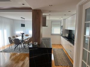 a kitchen and dining room with a table and chairs at Villa Vildana in Sarajevo