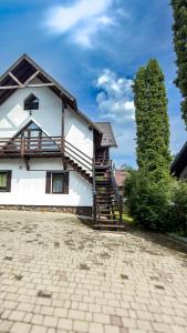 a large white house with a staircase on it at Olko House in Yaremche