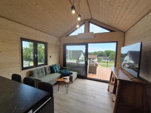 a living room with a couch and a tv at Eifelchalet Mendig in Mendig