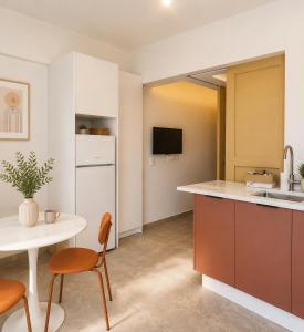 a kitchen with a table and a white counter top at Noéma Mani Boutique Residences in Gythio