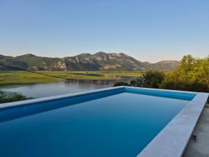 a swimming pool with a view of the mountains at LAKE VIEW PREVLAKA in Cetinje +27 photos