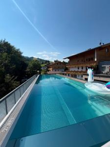 a swimming pool on the roof of a building at Geniesserhotel Minglers Sportalm 4 Sterne Superior in Kirchberg in Tirol