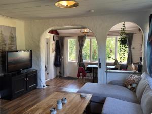 a living room with a couch and a table at Rustic Haven Bed and Breakfast -Entire Private Apartment 2km from Klarälvsbanan and Swimming area in Munkfors