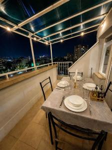 a table on a balcony with a view of the city at BM Aparts Rustic in Pleven