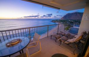 a balcony with a table and chairs and the ocean at Oceanfront Corner Unit , Hawaiian Princess in Waianae