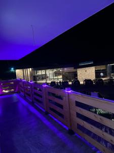a fence with purple lights in front of a building at Guesthouse Dritan Selimaj in Valbonë