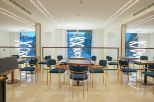 a room with tables and chairs and a window at Sambac hotel in Jeddah