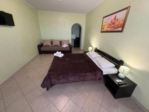 a hotel room with a bed and a couch at Hotel Olimp in Zatoka