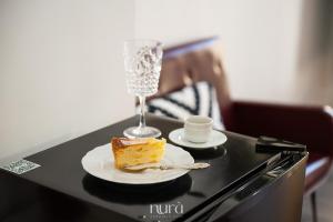 a table with a piece of cake and a glass of champagne at Wine Passion Room in Quartu SantʼElena