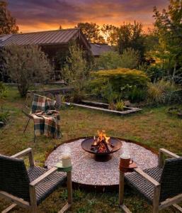 a fire pit in the middle of a yard at Le Chalet Lasseube in Lasseube
