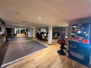 a large room with a video game machine in it at The President Hotel in Blackpool