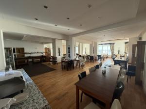 a large living room with a table and chairs at The President Hotel in Blackpool