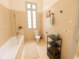 a bathroom with a tub and a toilet at Cosy Art Deco Apart Welcome to James's in Casablanca