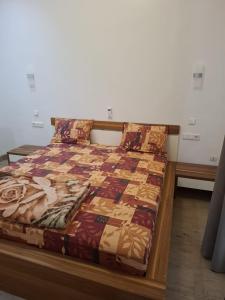 a bed with a quilt on it in a room at Keur Moussa in Dakar