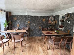 a restaurant with wooden tables and chairs in a room at Imperia in Akhaltsikhe