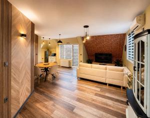 a living room with a couch and a table at BM Aparts Rustic in Pleven
