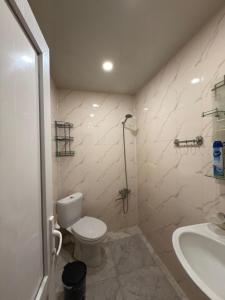 a bathroom with a toilet and a sink and a shower at Imperia in Akhaltsikhe +21 photos