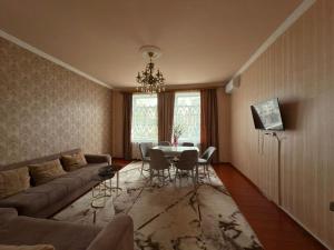 a living room with a couch and a table at Imperia in Akhaltsikhe