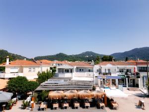 a view of a resort with tables and chairs at Orizon Apartments in Limenas