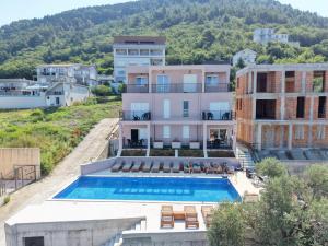 an aerial view of a building with a swimming pool at Dorado Apartments in Kavač