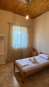 a bedroom with a large bed with a window at Todos home in Amalias