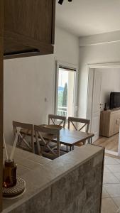 a dining room with a table and chairs in a kitchen at Luna di mare Igalo in Igalo +13 photos