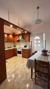 a kitchen with a table and a stove top oven at Todos home in Amalias