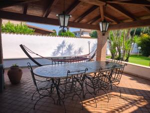 a table and chairs sitting on a patio at La casetta di Daniela in Sabaudia