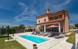 a villa with a swimming pool in front of a house at Danica in Smoljanci