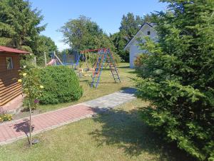 a yard with a playground with a swing at Zacisze in Kołczewo