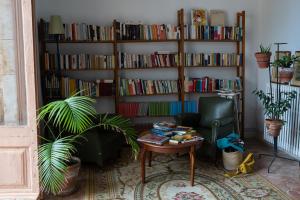 a living room with a book shelf filled with books at Can Traver de Besalú in Maia de Montcal