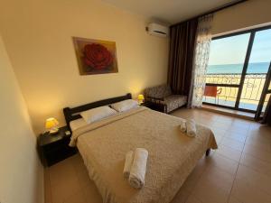 a bedroom with a bed with a view of the ocean at Hotel Olimp in Zatoka