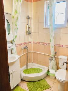 a bathroom with a tub and a toilet and a sink at Villa Jovan Gevgelija in Gevgelija +47 photos