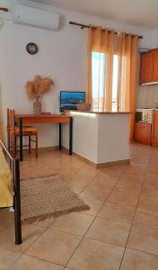 a kitchen with a table and a dining room at Ammoudeli Coastal Escape in Plomari +43 photos