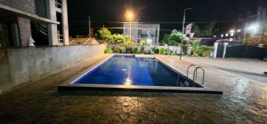 a swimming pool in the middle of a street at night at Jumber&Lela in Batumi