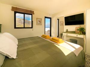 a bedroom with a bed with a flat screen tv at Sunset Terrace Studio - Ocean View - Top Floor in Buenavista del Norte