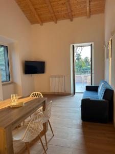a living room with a table and a couch at Serenity House Latina in Latina +12 photos