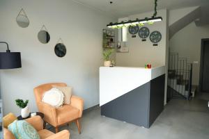 a living room with a counter and a chair at Nuvelle Boutique Hotel in Prizren