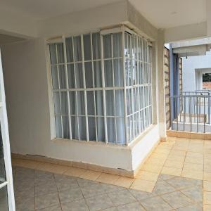 a room with a barred window on a balcony at RyNa Homes in Meru