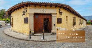 a building with a large wooden door on a street at Casa Faustina Boutique Hotel in Antigua Guatemala +28 photos