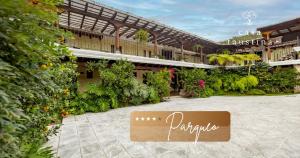 a sign in front of a building with plants at Casa Faustina Boutique Hotel in Antigua Guatemala