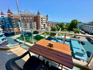 a wooden bench sitting on top of a balcony at Menada Apartments in Sunny Beach in Sunny Beach