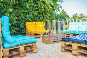 a patio with two chairs and a couch and a table at Campagne et Mer in Perpignan