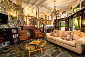 a living room with a couch and a table at 3 Bedroom Villa with Pool and Ocean Views in Cap Estate