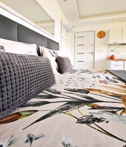 a bedroom with a bed with a blanket on it at Private wellness with panoramic view, sauna & jacuzzi in Maribor