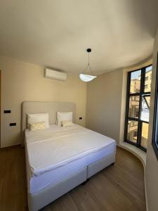 a bedroom with a white bed in a room at Belle cote appartement al hoceima in Al Hoceïma
