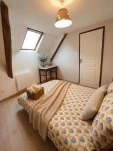 a bedroom with a bed with a basket on it at Le Noble Jardin in Mohon +15 photos