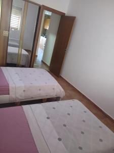 a bedroom with two mattresses and a mattress sidx sidx sidx at Amsa Tetouan in Chozas +28 photos