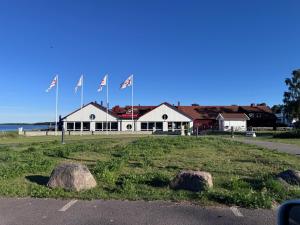 a building with flags on top of a field at Idyllic house in Timmernabben in Timmernabben