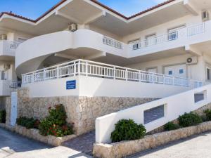 a large white building with balconies on it at MARGIANNA APARTMENTs Seaside Studio in Káto Ássos